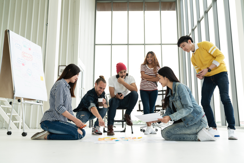 group of people having a brainstorm session, team building exercise