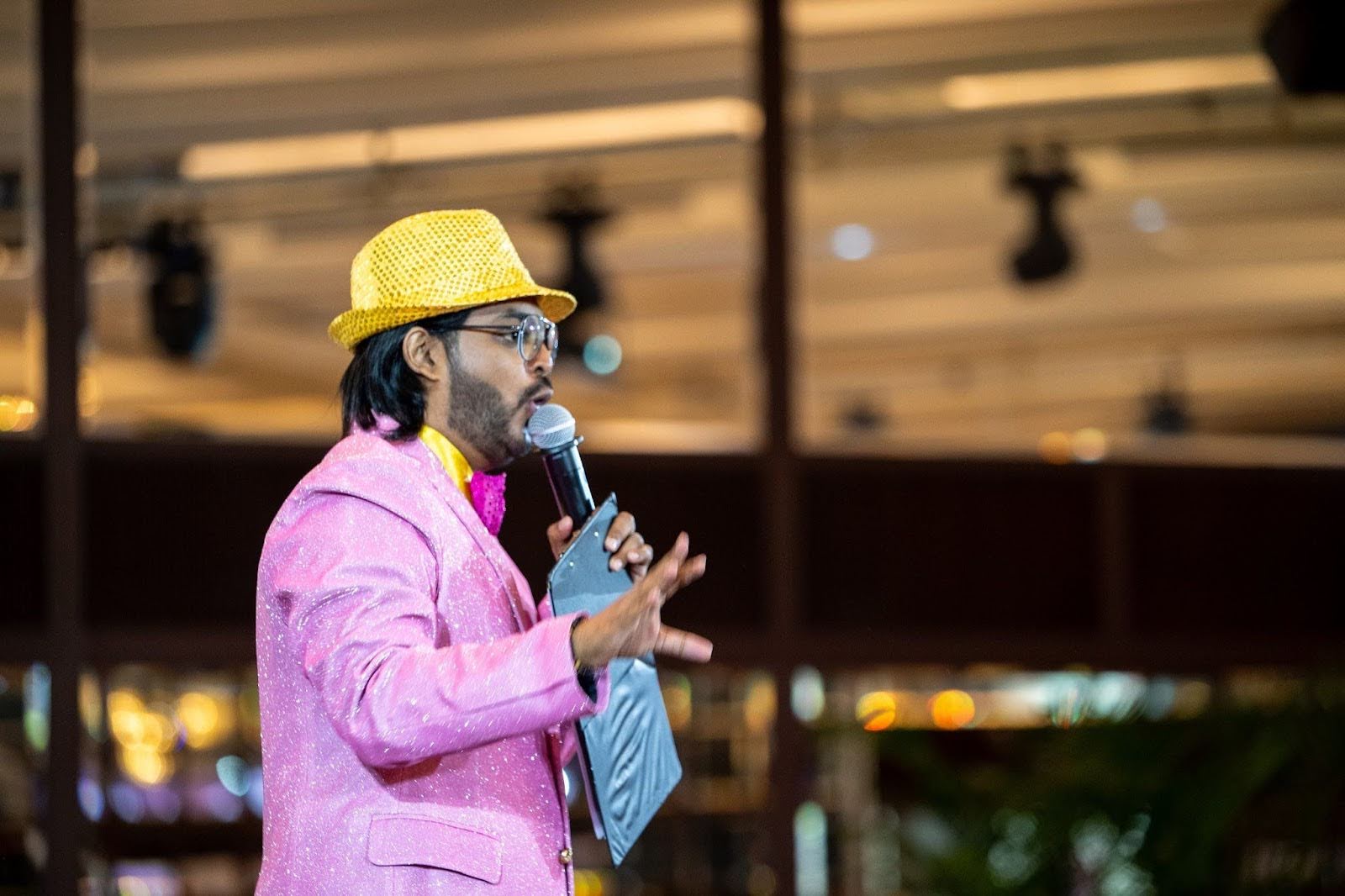 Professional event emcee hosting a corporate conference in Singapore.