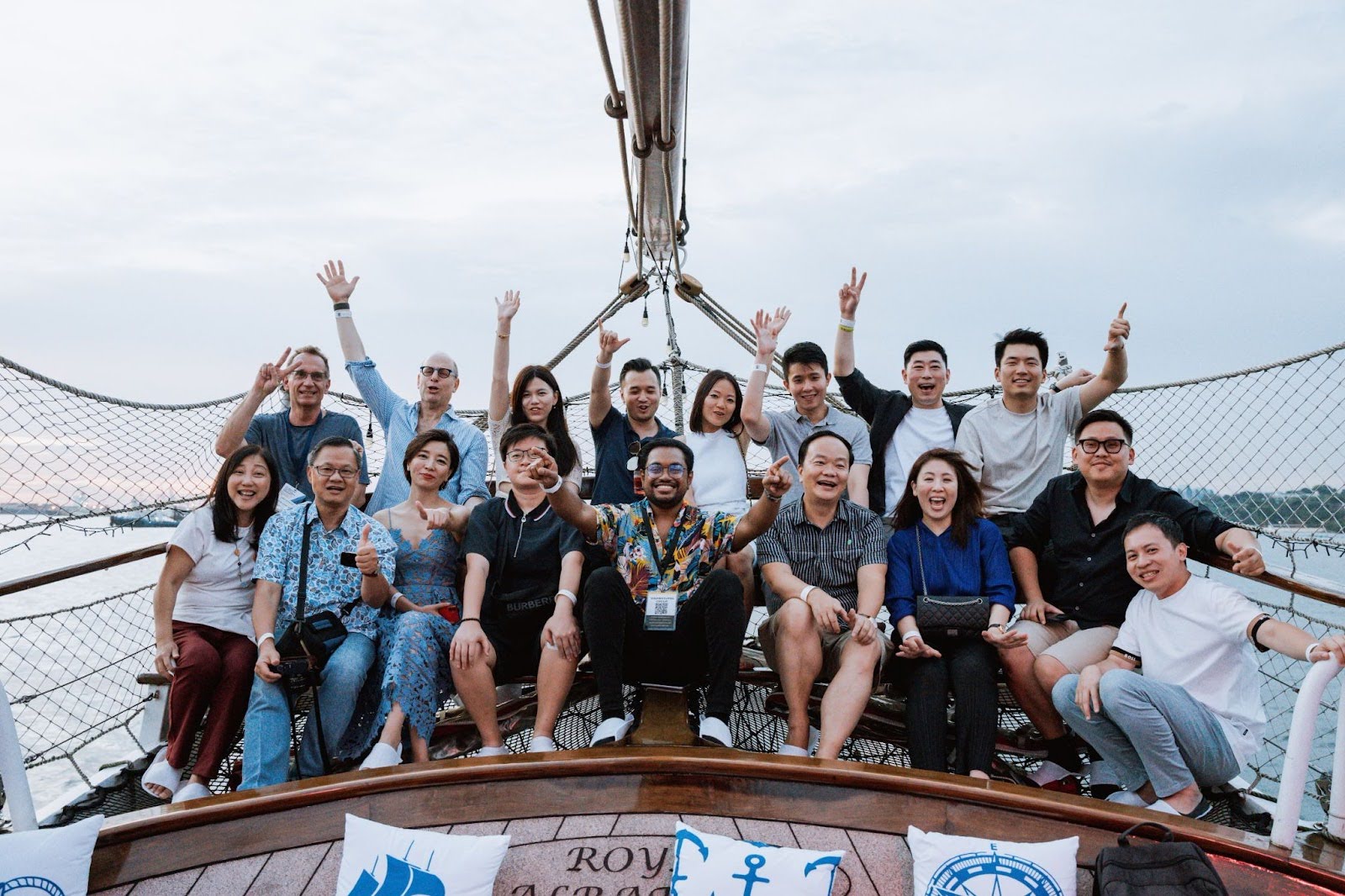 Team bonding on a sailing ship during overseas retreat.